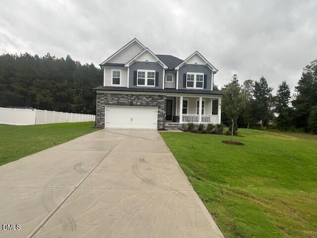 Two-story gray and stone new construction home with front porch and 2-car garage in Wellers Knoll, Lillington, North Carolina