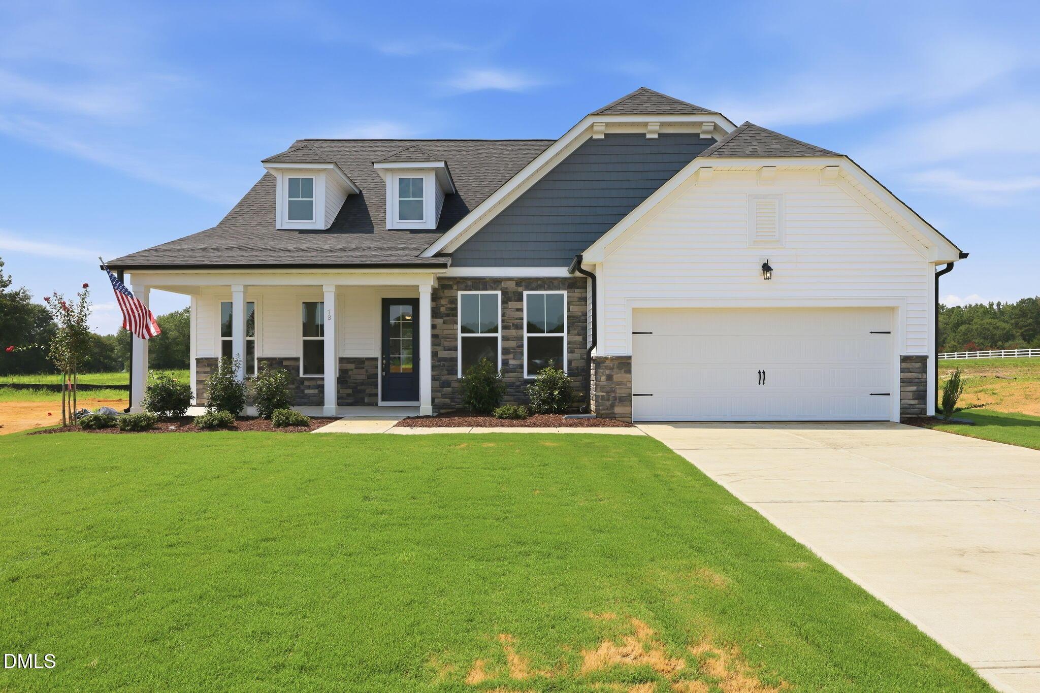 The Magnolia B floor plan by Davidson Homes in Retreat at North Main, Lillington, NC features a 2-car garage and porch.