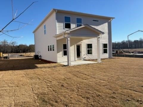 Two-story white Rabun C home by Davidson Homes in Cedar Farms, Winder, Georgia, featuring covered front porch and large windows