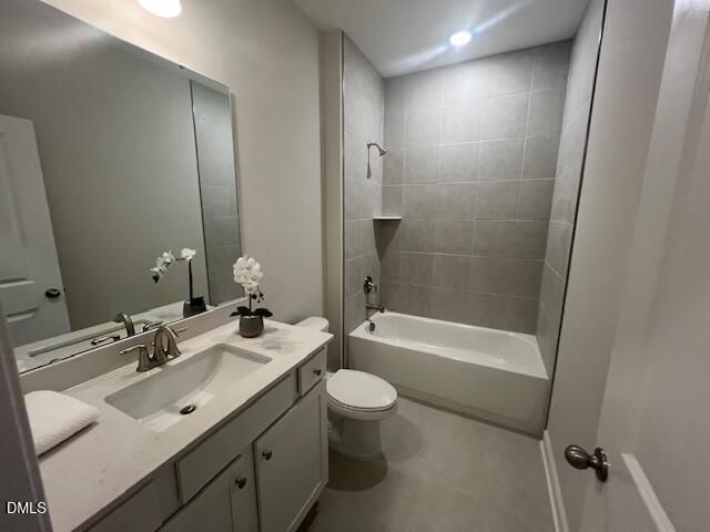 Modern bathroom with quartz vanity, soaking tub, walk-in shower, and gray tile in 4-bedroom Preston A home, Lillington NC