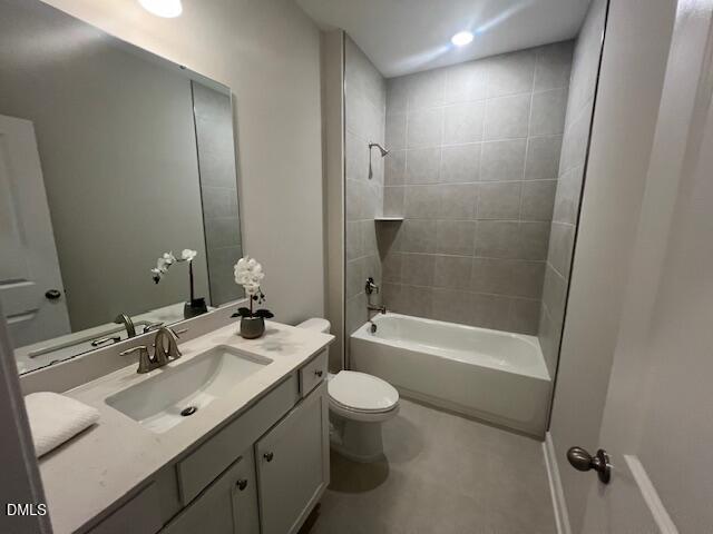 Modern bathroom with quartz vanity, soaking tub, walk-in shower, and gray tile in 4-bedroom Preston A home, Lillington NC