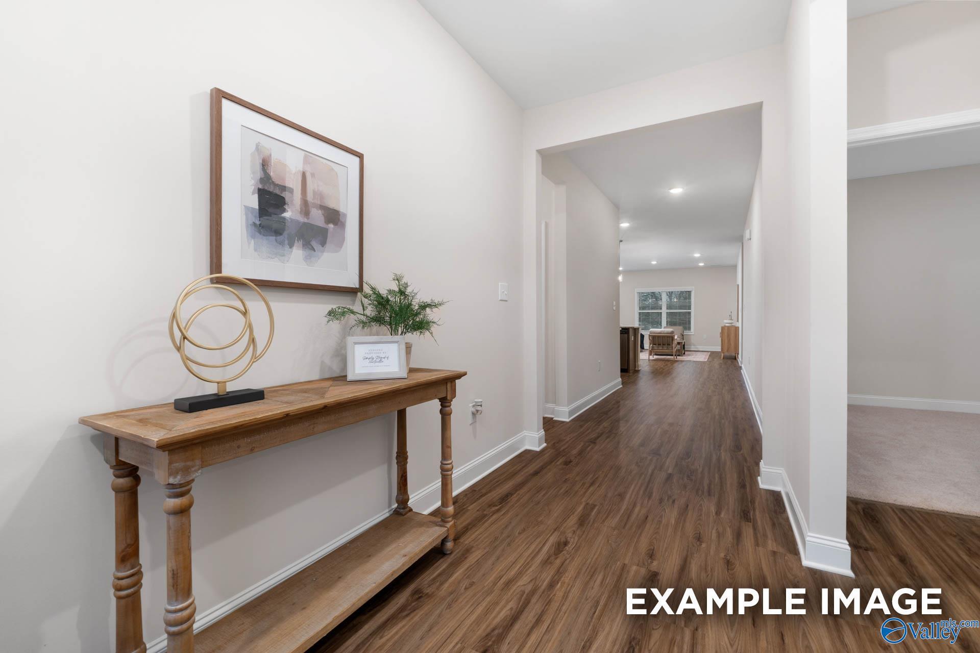 Bright entryway with wood-look flooring and console table in The Daphne D floor plan by Davidson Homes, Huntsville, Alabama.