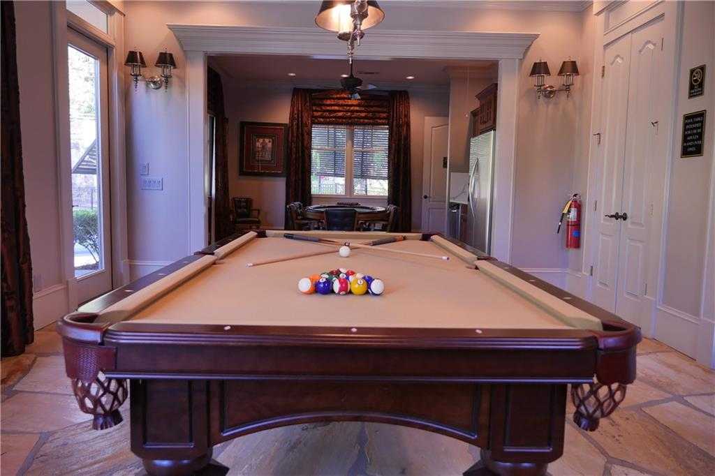 Elegant mahogany billiards table with racked balls in spacious game room of Davidson Homes The Seaside B, Woodstock, Georgia