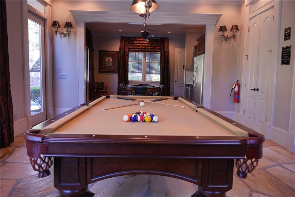 Elegant mahogany billiards table with racked balls in spacious game room of Davidson Homes The Seaside B, Woodstock, Georgia