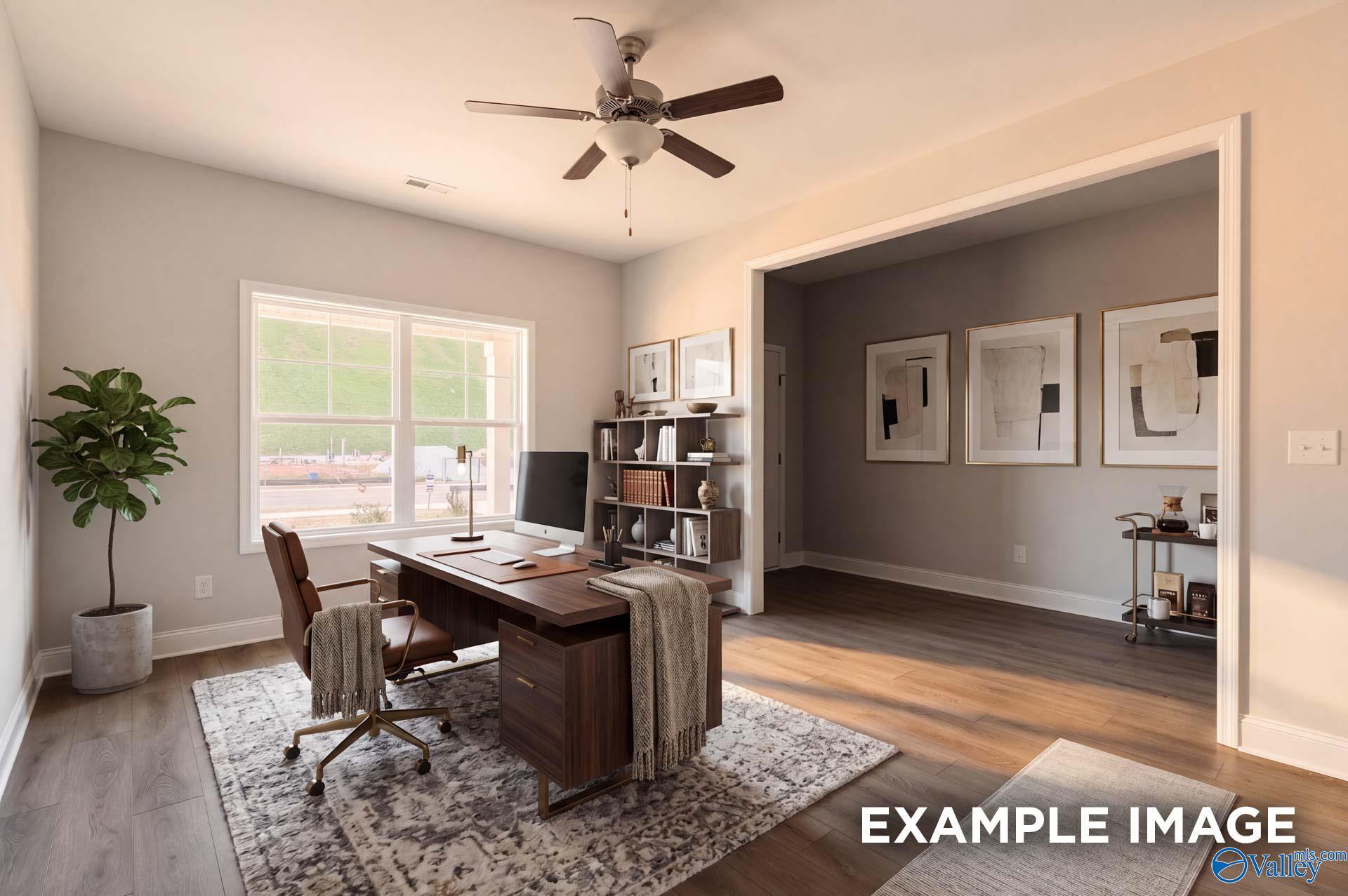 Modern home office with wood desk and area rug in The Chelsea D floor plan by Davidson Homes in Cullman, Alabama.
