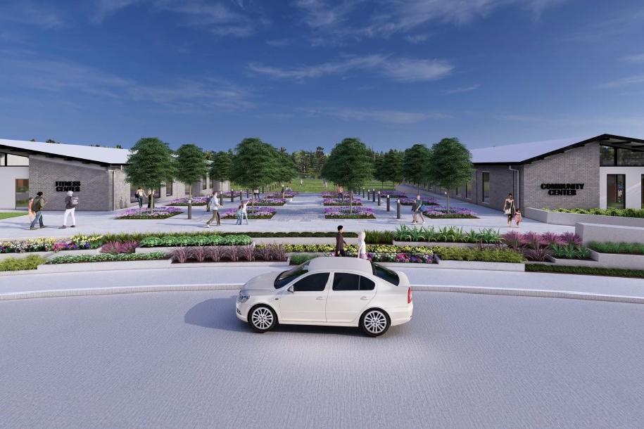 Modern clubhouse at Sundance Cove in Crosby Texas featuring sloped roofs, vibrant flower beds, walking paths and lush trees