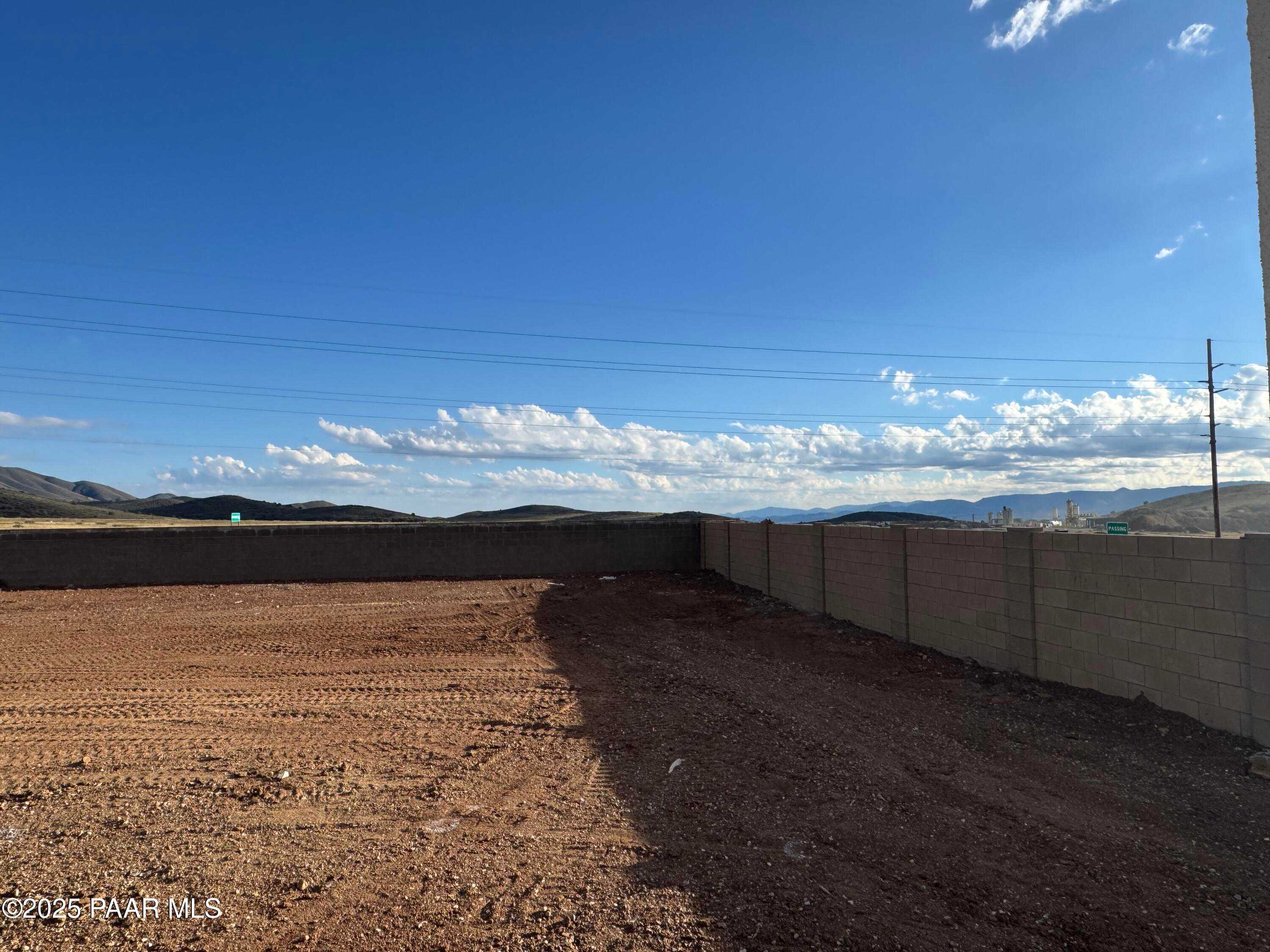 Expansive dirt construction lot with mountain backdrop and clear skies in Morningstar, Prescott Valley, Arizona, for Evermore Homes Sunrise A