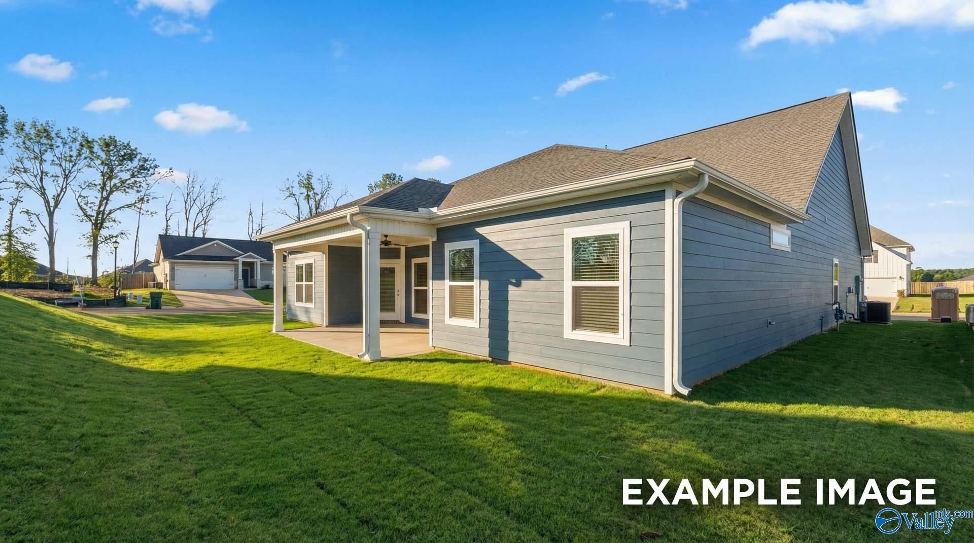 Modern two-story gray home exterior with covered porch, large windows, and green lawn in Anderson Farm, Athens, Alabama
