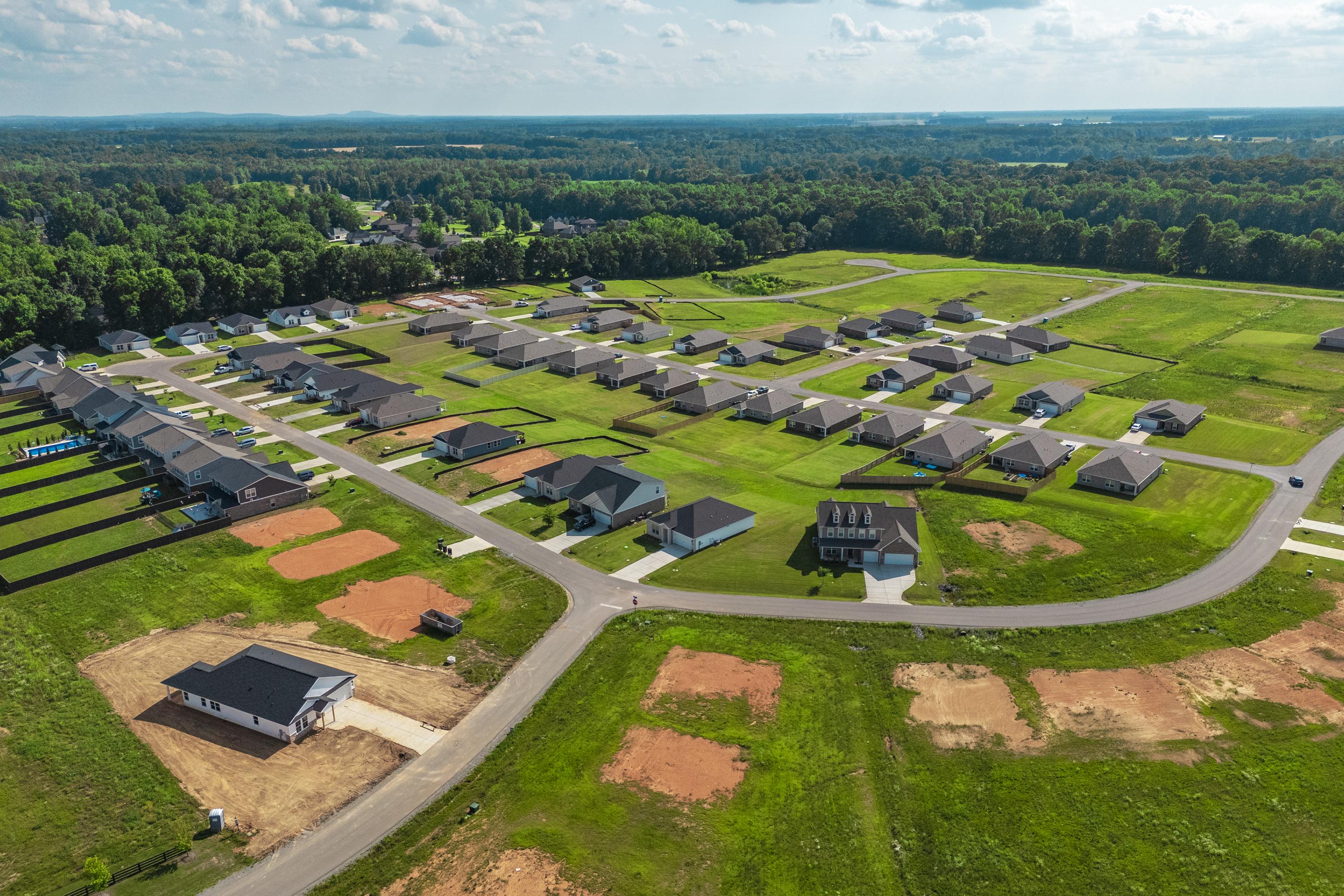 Aerial view of Bailey Park in Fayetteville TN featuring new Davidson Homes amid green lawns, construction sites and wooded surroundings