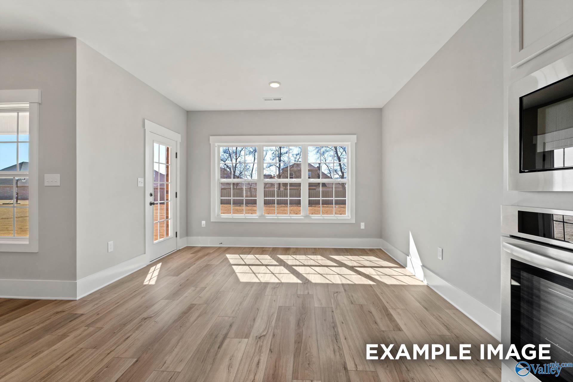 Sunlit breakfast nook with wood-look flooring and backyard views in The Finleigh floor plan, Briercreek, Meridianville.
