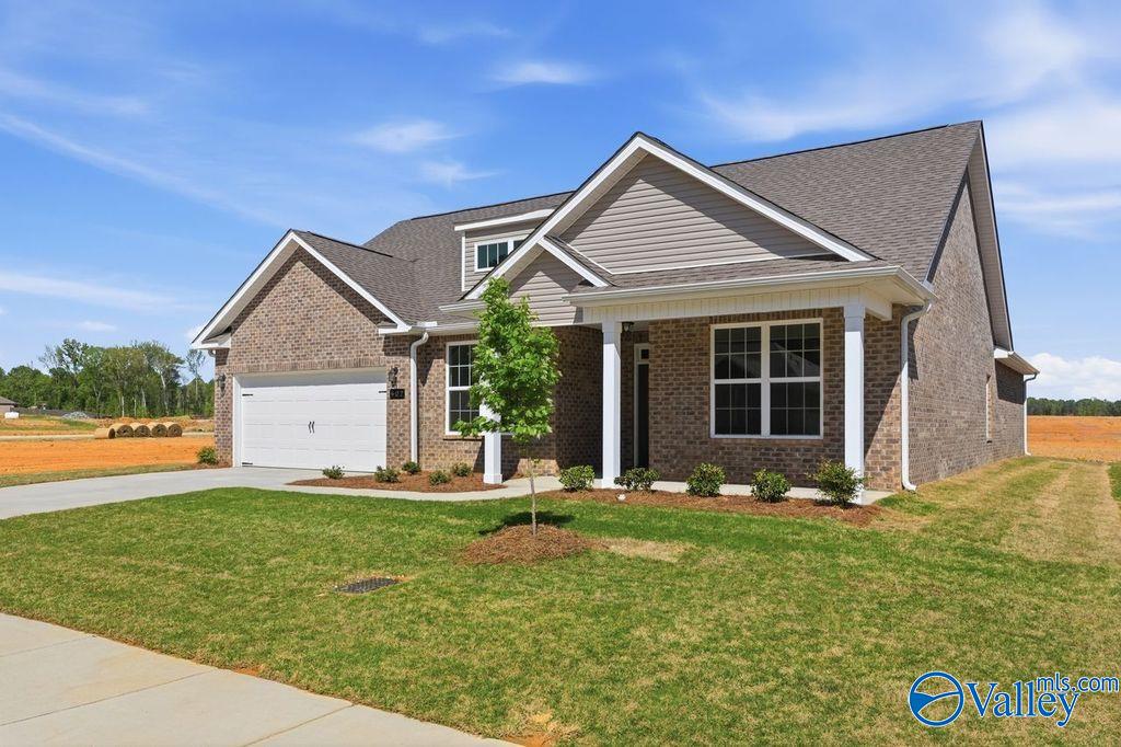 Modern brick single-story home with covered porch, 2-car garage, and landscaped yard in Cain Park, Hartselle, Alabama - Davidson Homes The Harrison