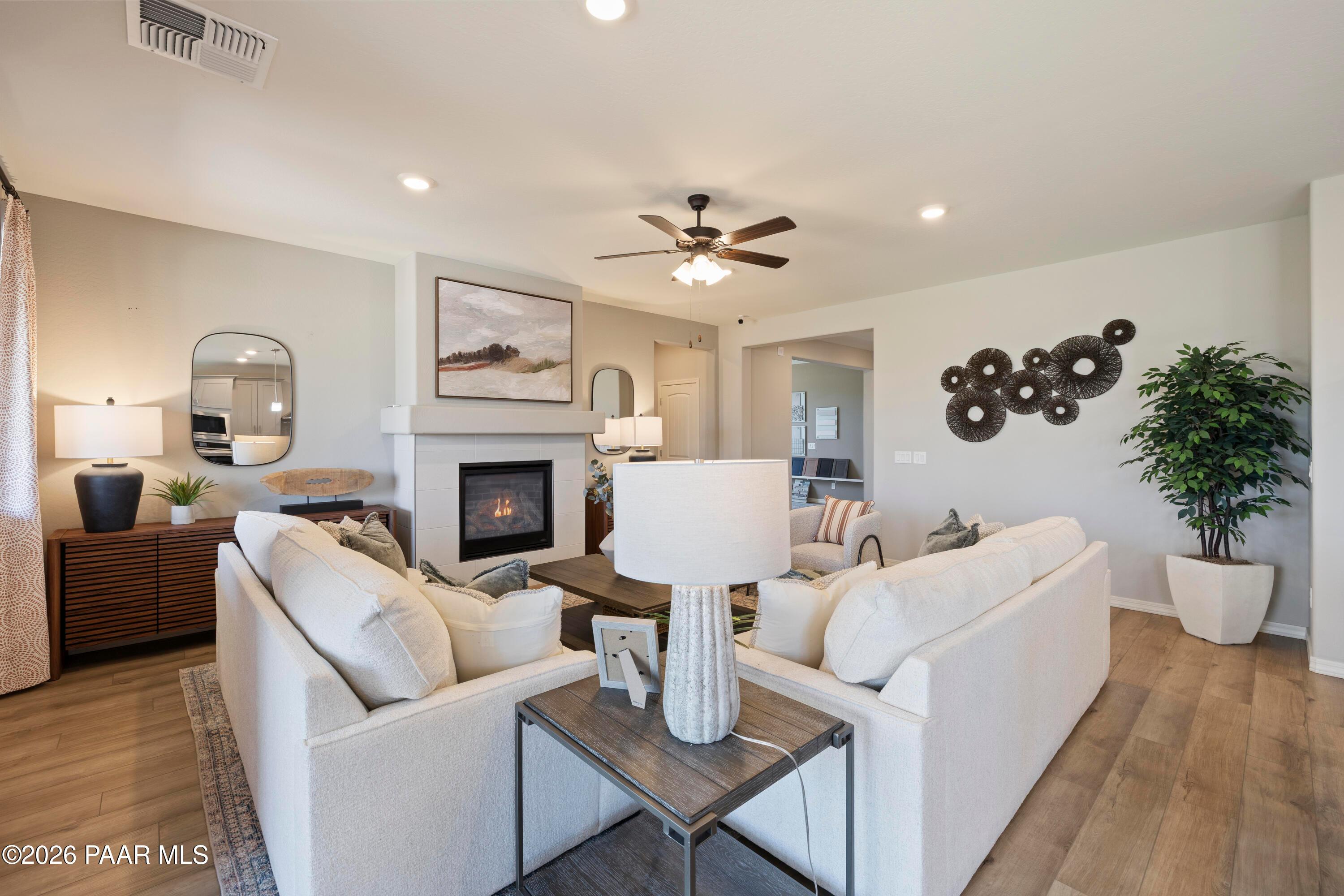 Cozy living room with fireplace and modern decor in The Harmony A floor plan at Pronghorn Ranch, Prescott Valley, Arizona.