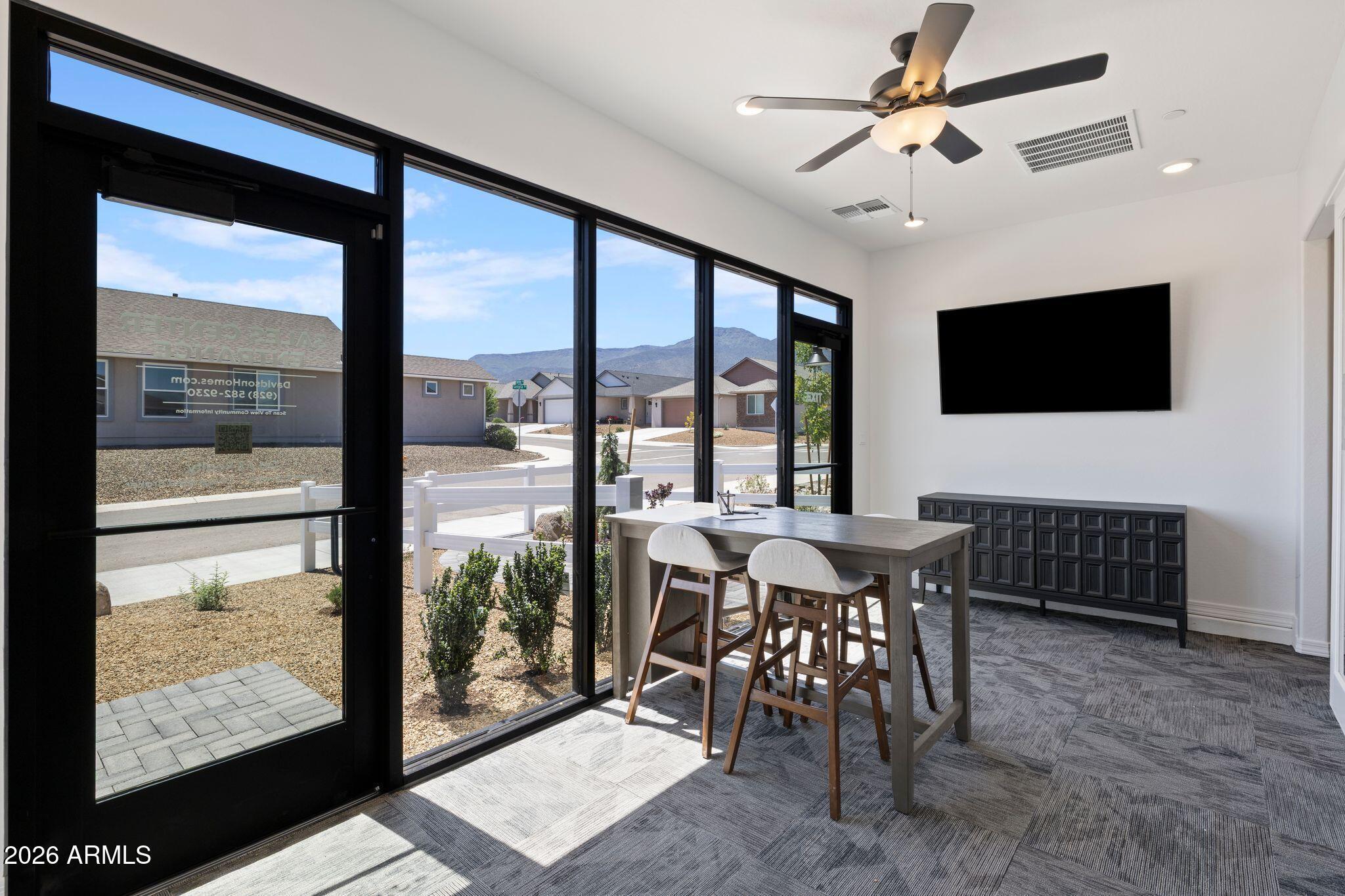 Bright sales office with floor-to-ceiling windows in a Davidson Homes community at Vineyards at Cottonwood, Arizona.