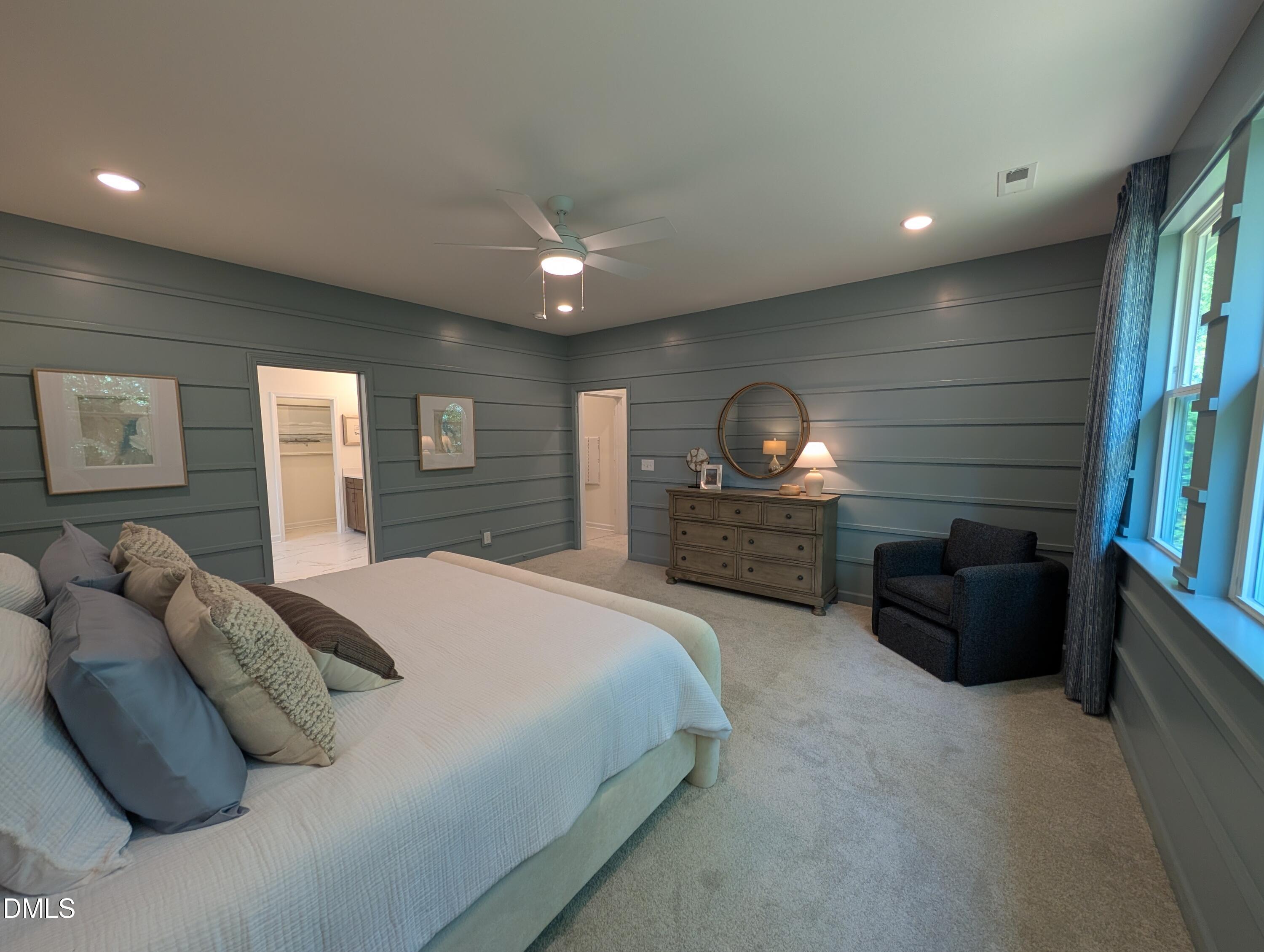 Spacious primary bedroom with blue shiplap walls in The Aspen B floor plan at Wendell Ridge in Wendell, North Carolina.
