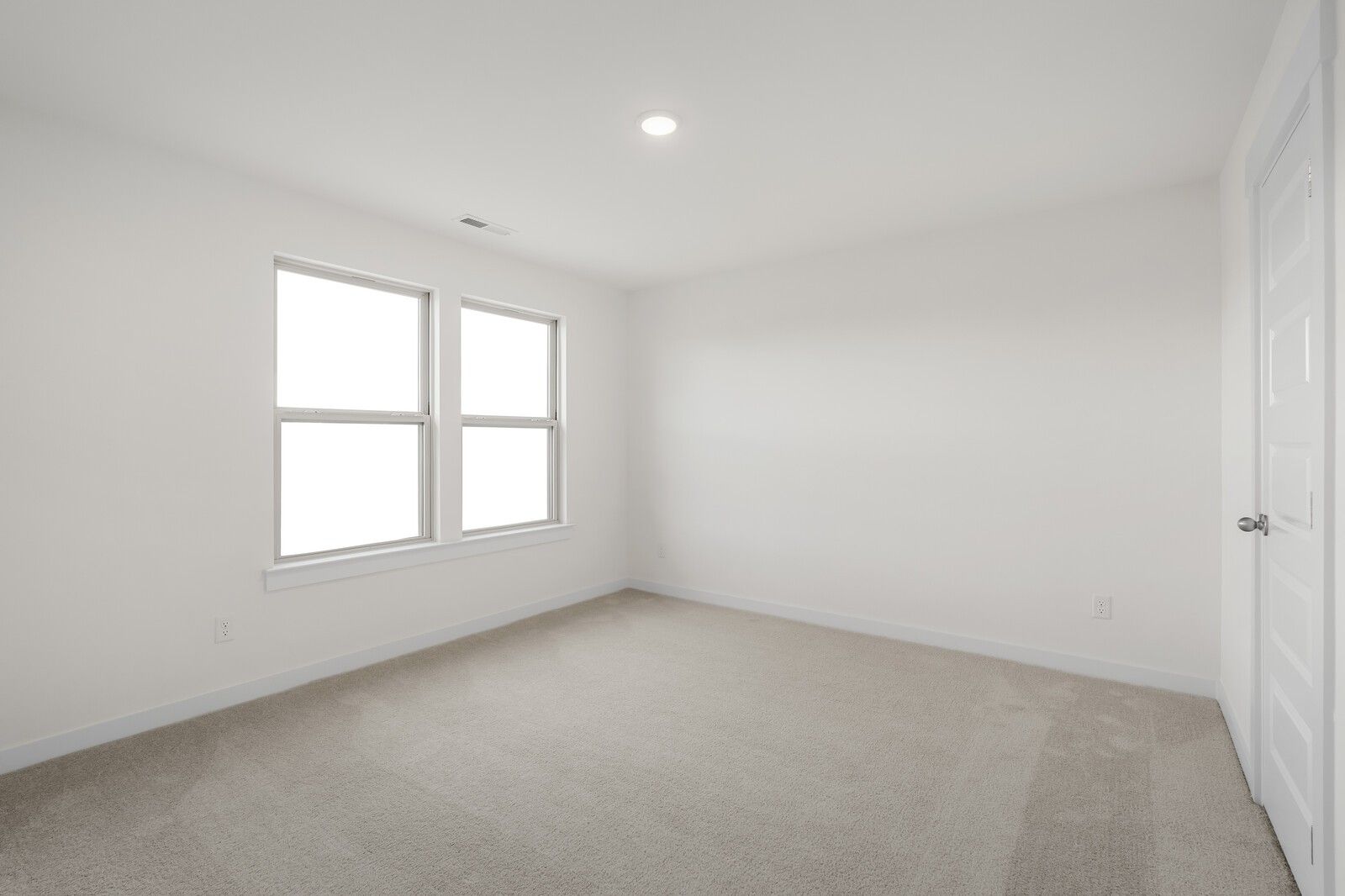 Bright secondary bedroom with large windows, neutral carpet and white walls in Davidson Homes The Willow C, Gallatin, TN