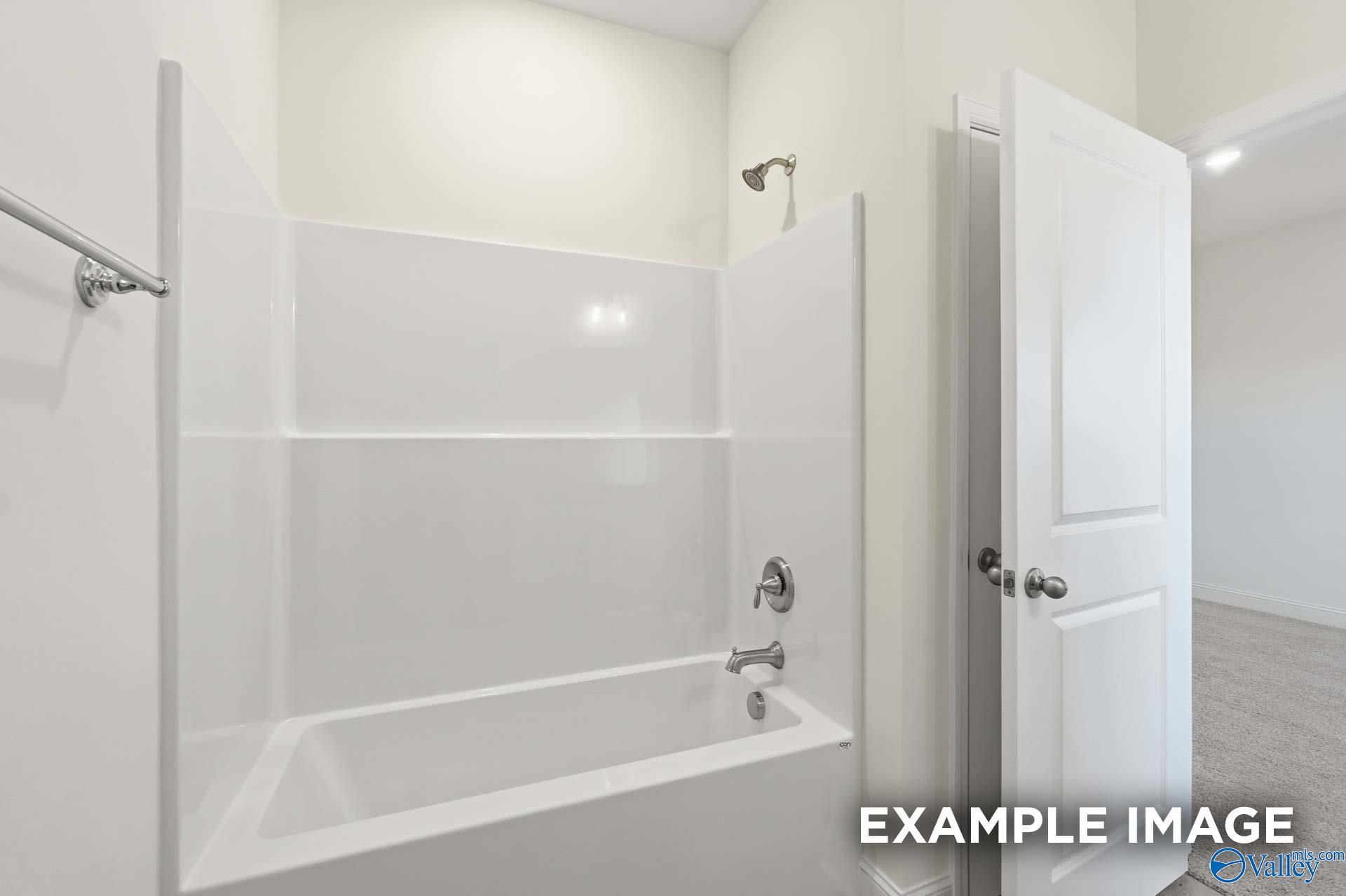 Modern white bathtub and shower combination in The Valencia floor plan by Davidson Homes in Briercreek, Meridianville.