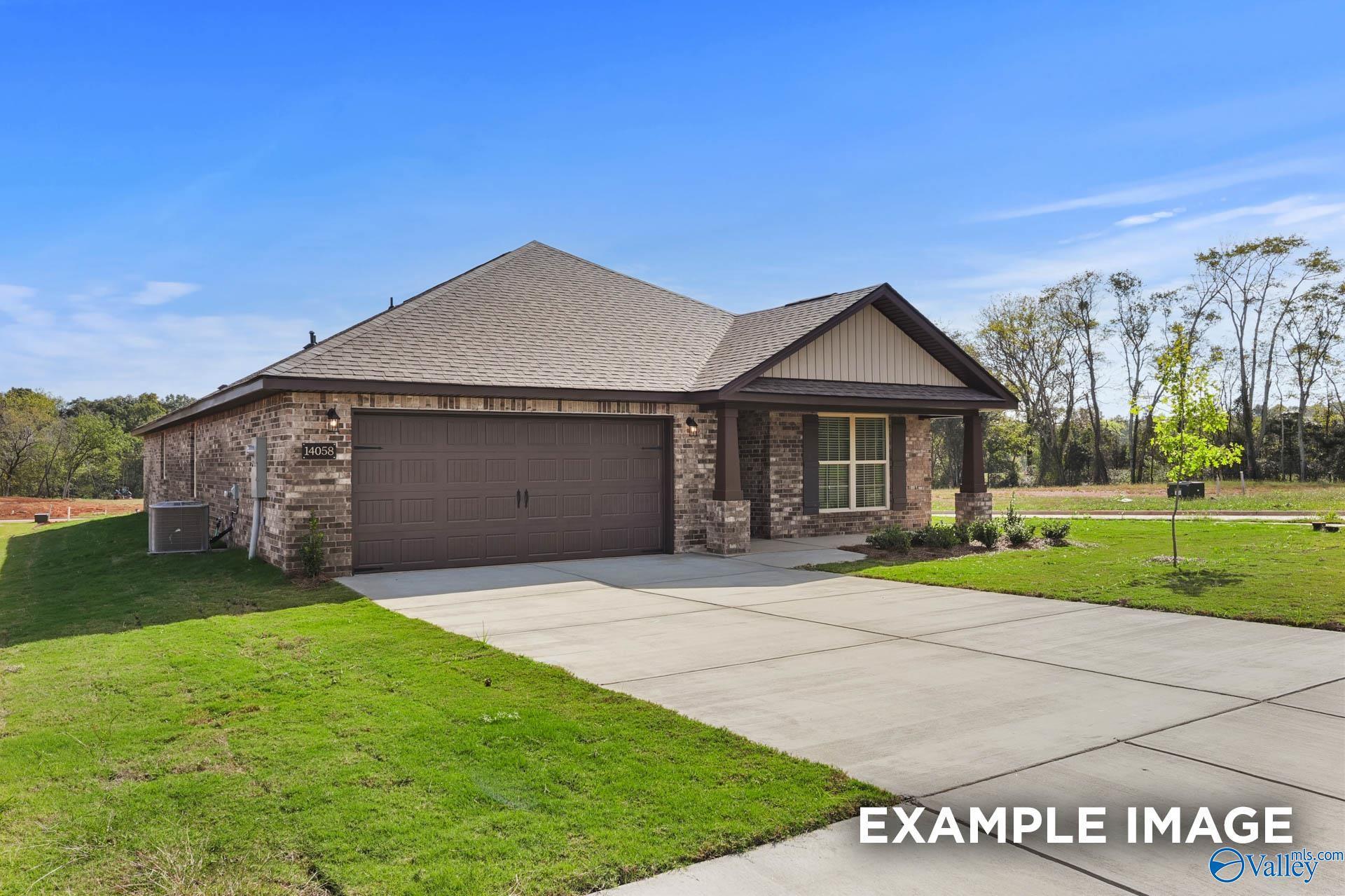 Modern single-story brick home with 2-car garage, covered porch, driveway and lush yard in Wood Trail, Toney, Alabama - Davidson Homes Everett B