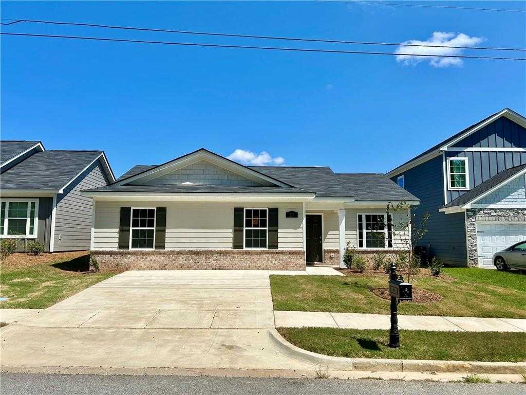 Charming 1-story 3-bedroom Davidson Homes Washington plan with white siding, brick accents, gabled roof, and driveway in Phenix City, Alabama