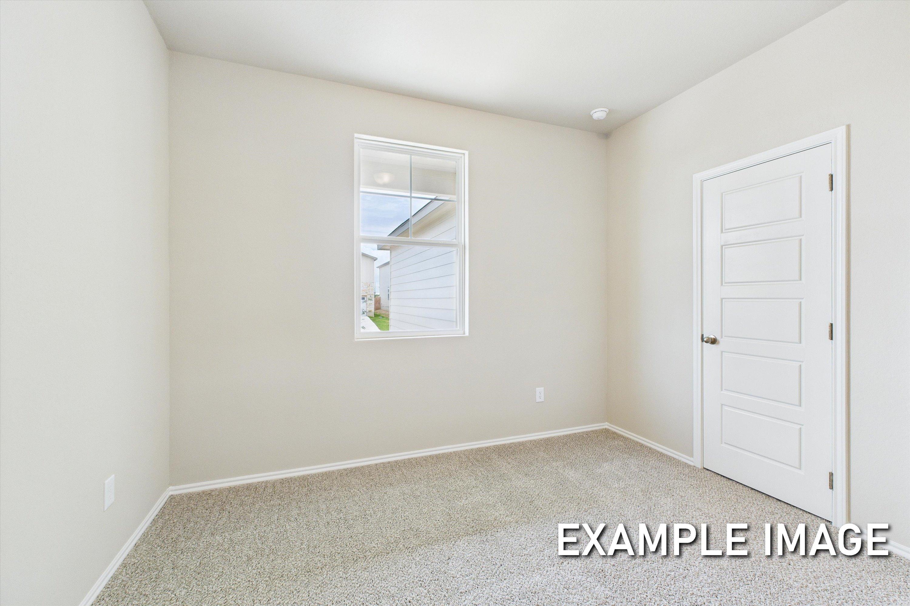 Bright bedroom with plush carpeting and natural light in The Comal single-family home design by Davidson Homes.