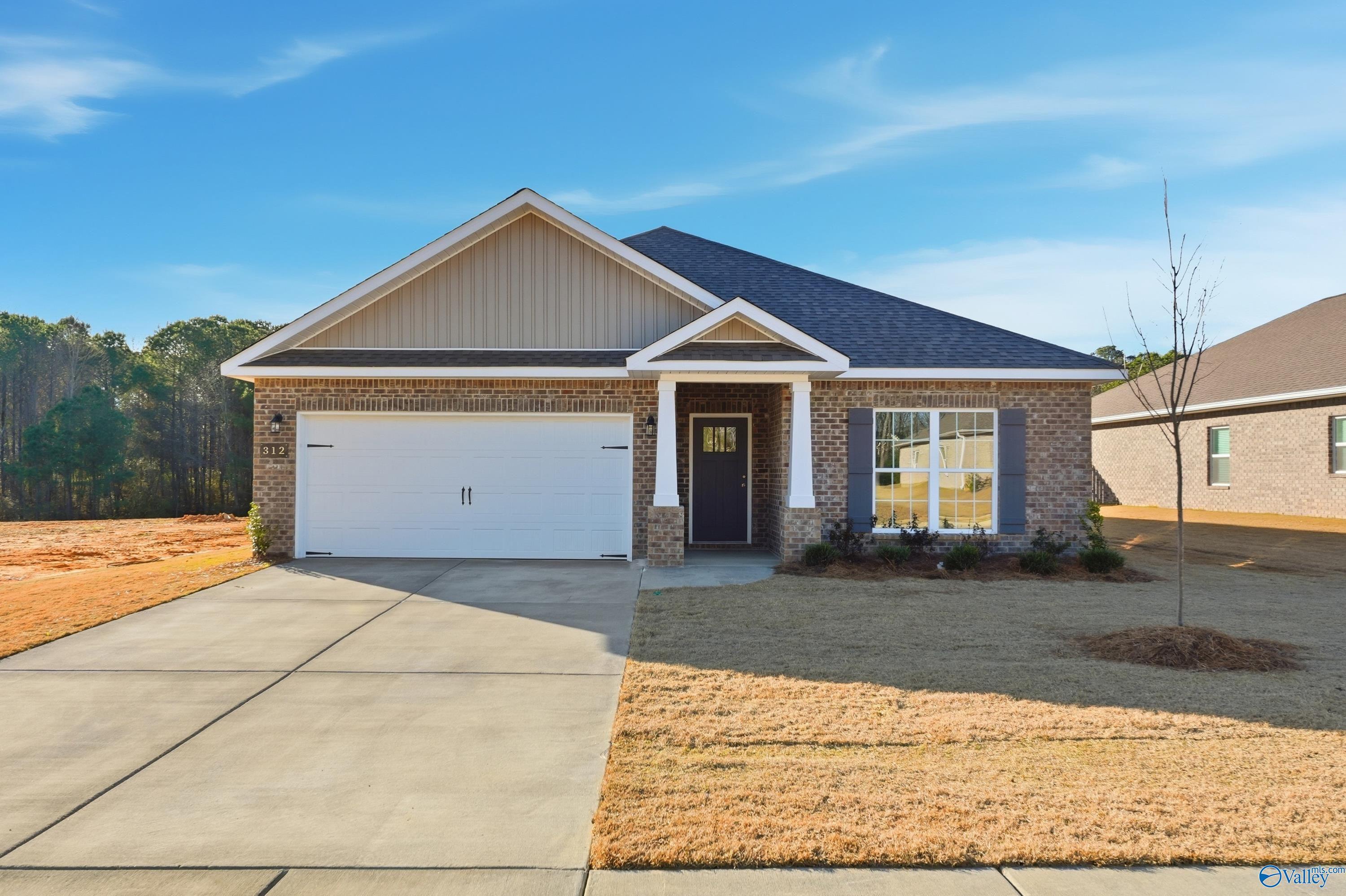 Modern single-story 4-bedroom home with 2-car garage, brick accents, and landscaped yard in The Highlands, Arab, Alabama
