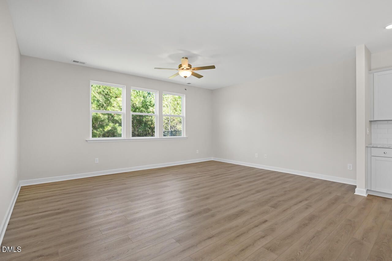 Bright open-concept living area with luxury vinyl plank flooring and natural light in Davidson Homes The Preston B, Wendell Ridge, NC