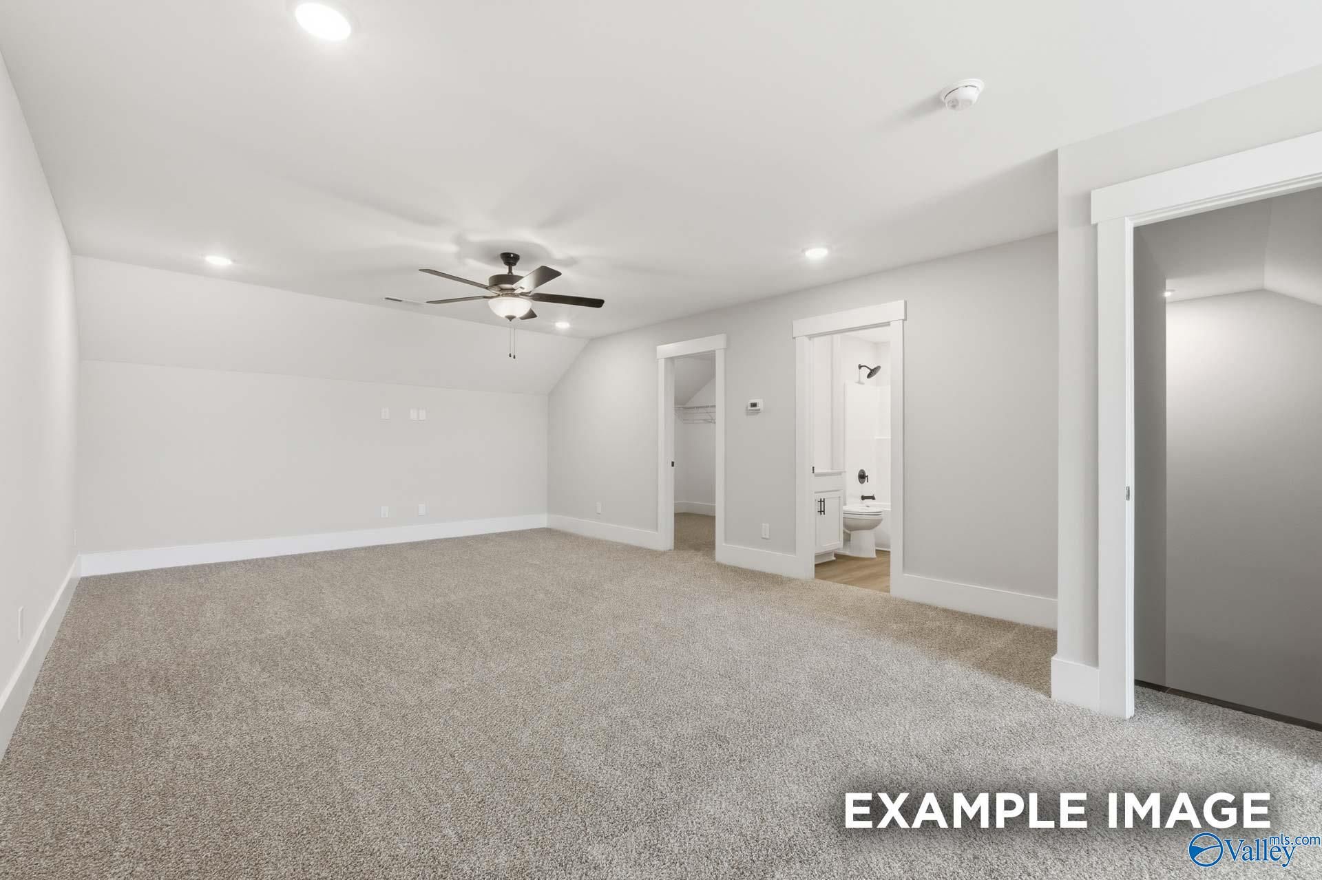 Spacious carpeted bonus room with ceiling fan in The Rockford floor plan by Davidson Homes in Briercreek, Meridianville.