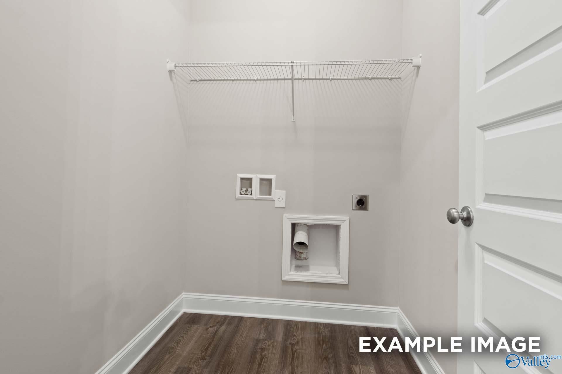 Spacious laundry room with wire shelving, washer-dryer hookups in The Camilla A by Davidson Homes, Hartselle, AL