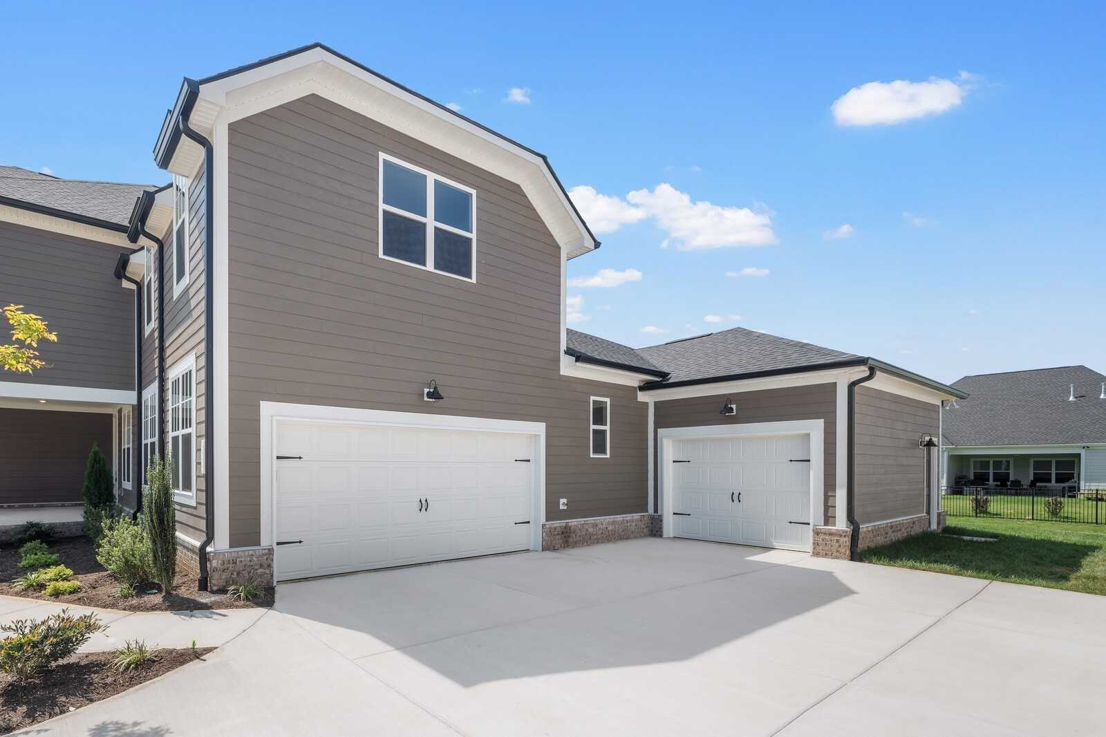 Gray two-story home with 3-car garage, white trim, and driveway in Shelton Square, Murfreesboro, Tennessee - Davidson Homes The Hathaway