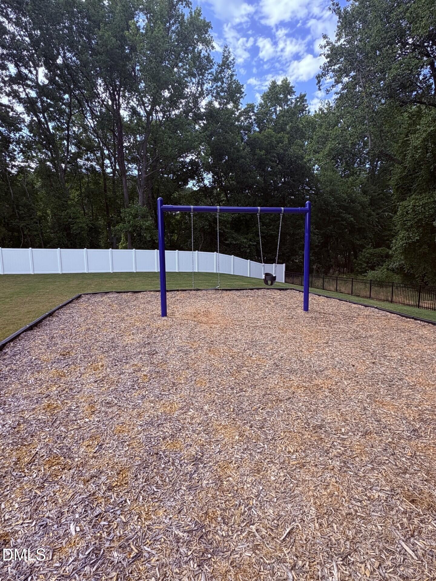 Community playground with swing set in Woodland Crossing, Zebulon, North Carolina by Davidson Homes.