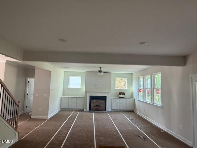 Spacious living room with fireplace and custom built-ins in Hickory II B floor plan at Montrose, Aberdeen, North Carolina.