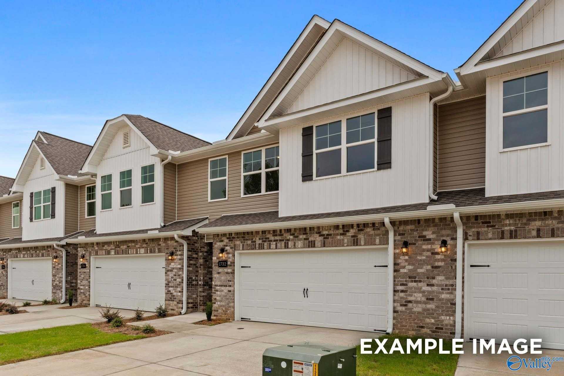 Modern two-story townhomes with brick accents, white siding, and two-car garages in Pavilion, Huntsville, Alabama by Davidson Homes The Camden D