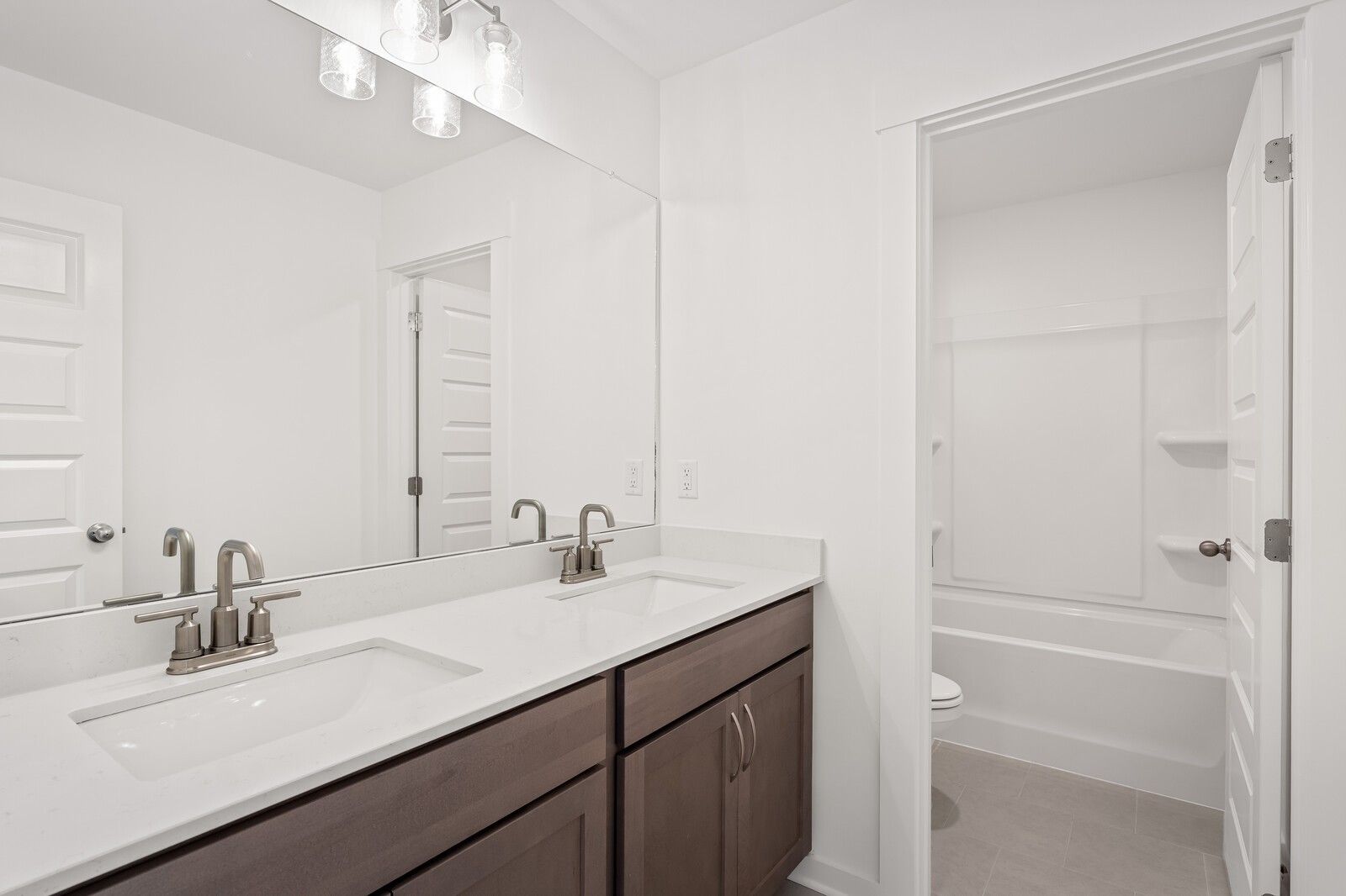 Spacious double vanity bathroom with soaking tub and modern fixtures in Davidson Homes The Ash C, Mt. Juliet
