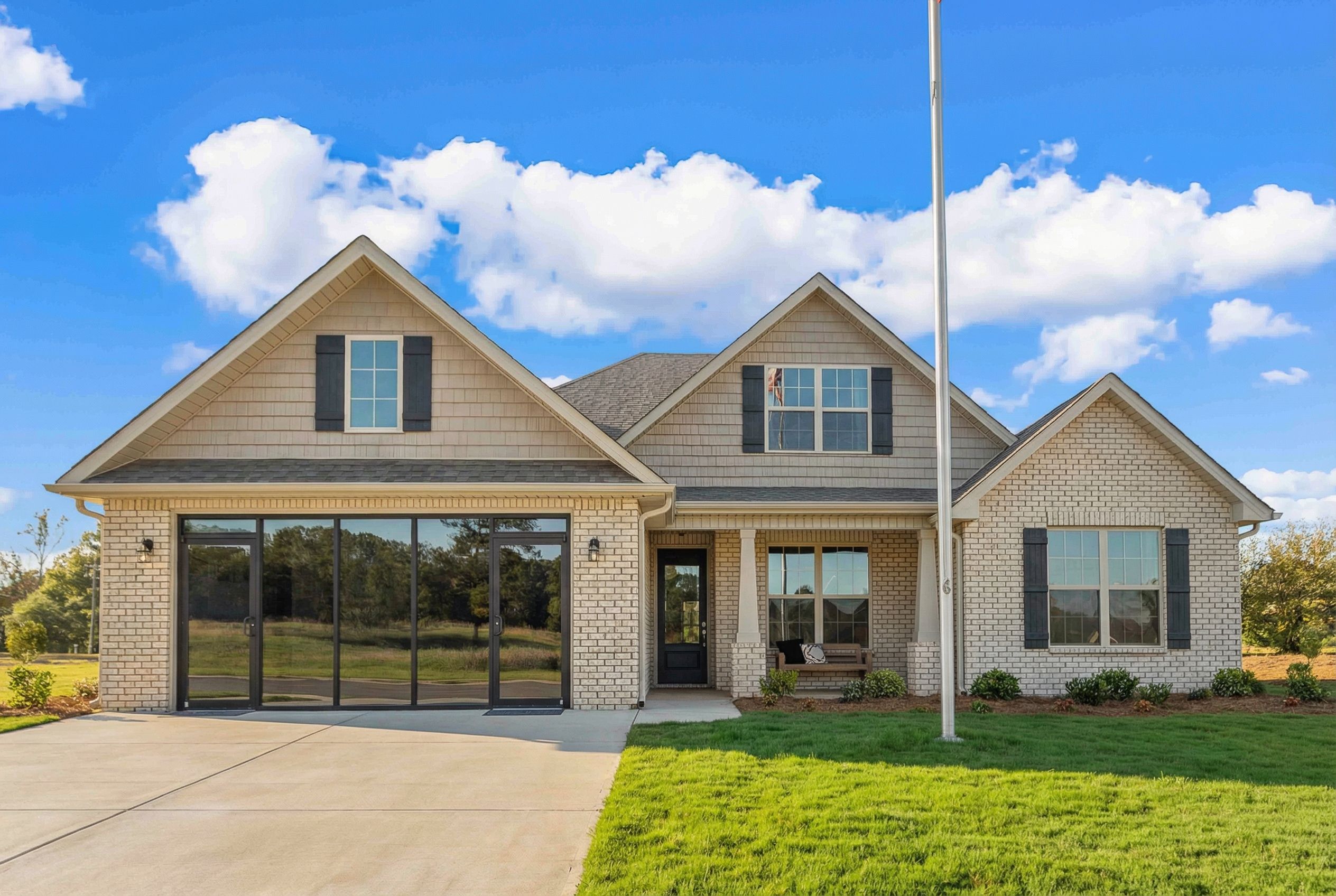 Modern Craftsman home exterior at Cain Park in Hartselle, Alabama with two-car garage and gabled roof