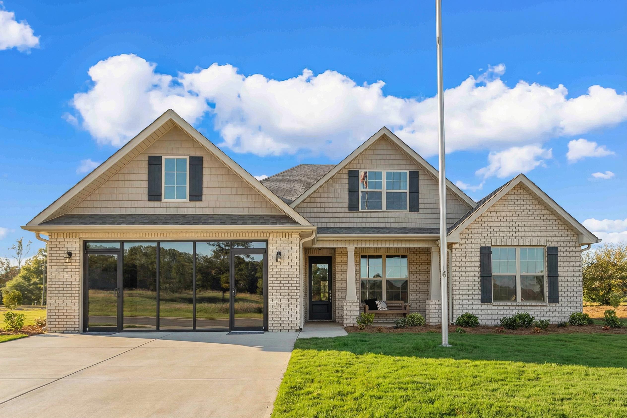 Modern Craftsman home exterior at Cain Park in Hartselle, Alabama with two-car garage and gabled roof