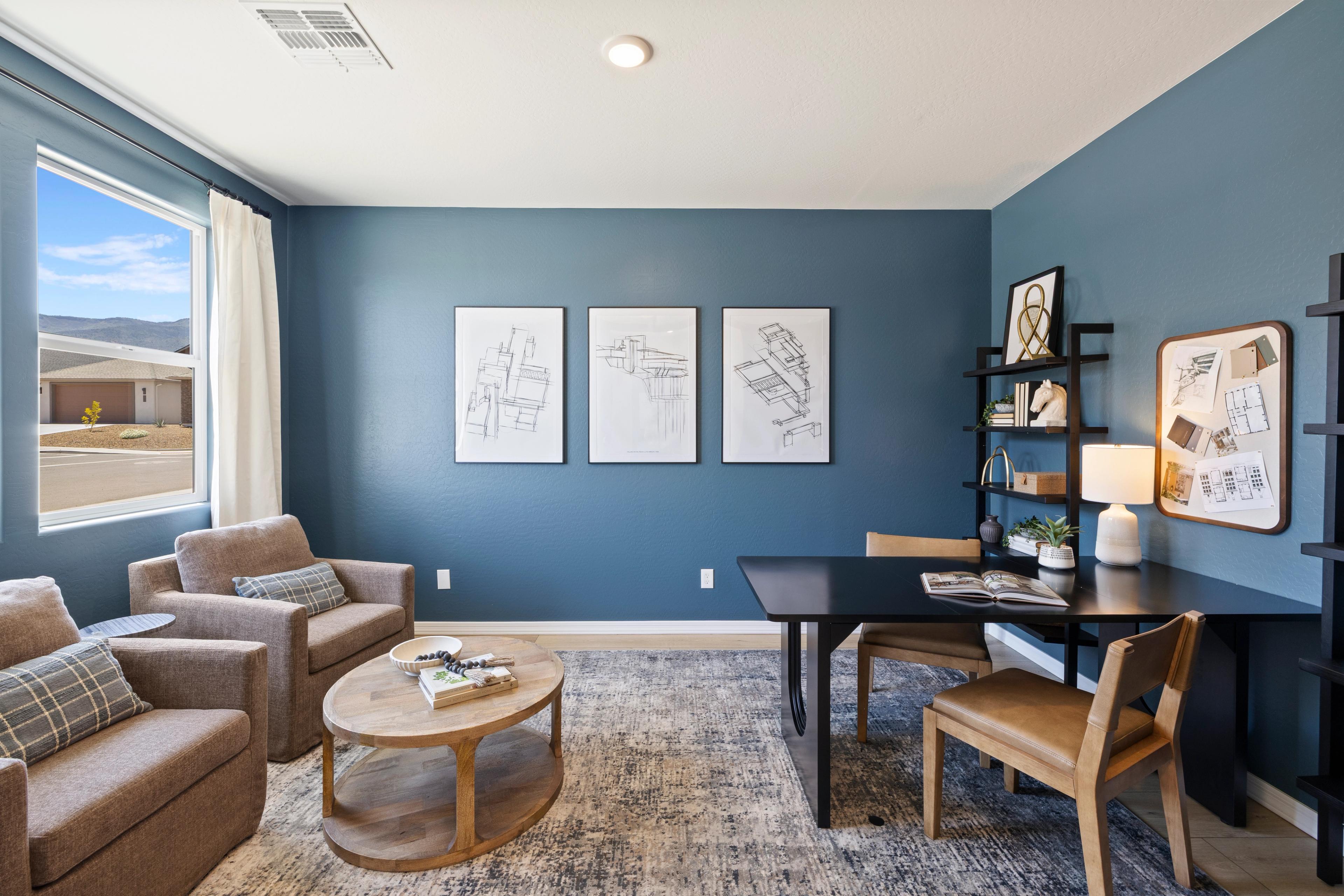 Modern home office with blue walls, desert mountain view, wooden desk, armchairs at Vineyards at Cottonwood, Cottonwood AZ