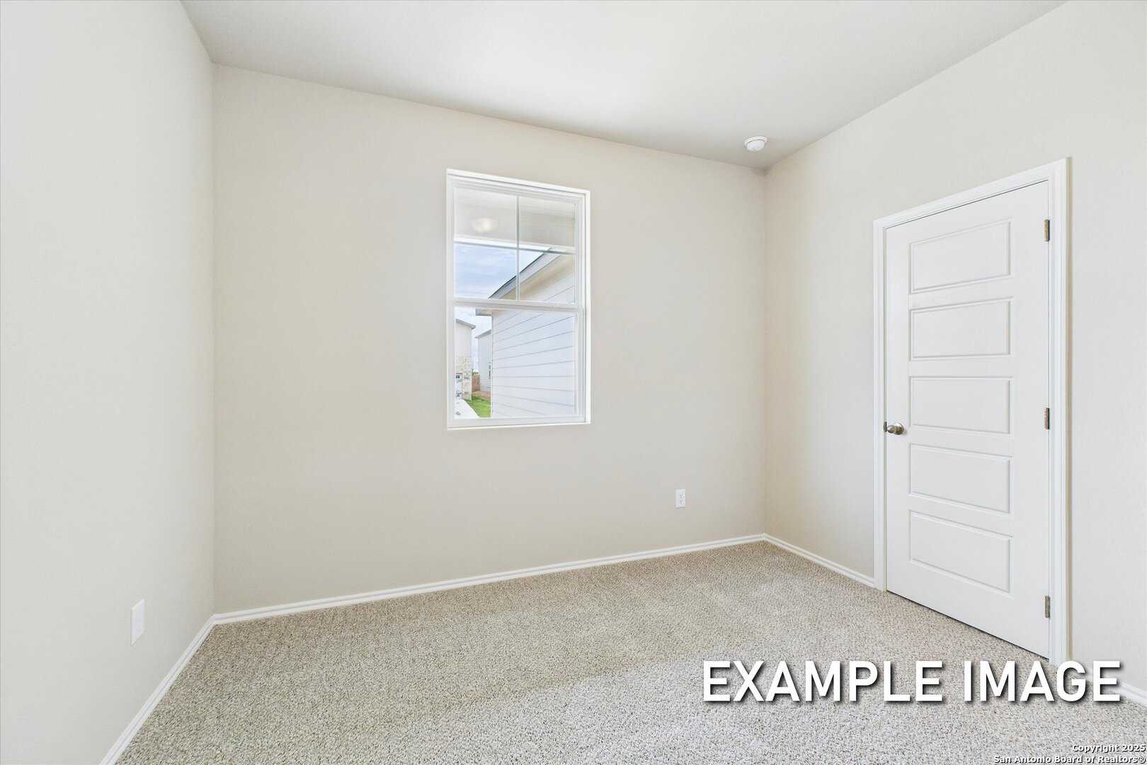 Bright secondary bedroom with beige walls, large window, white door, and carpeted floor in Davidson Homes The Comal B, San Antonio