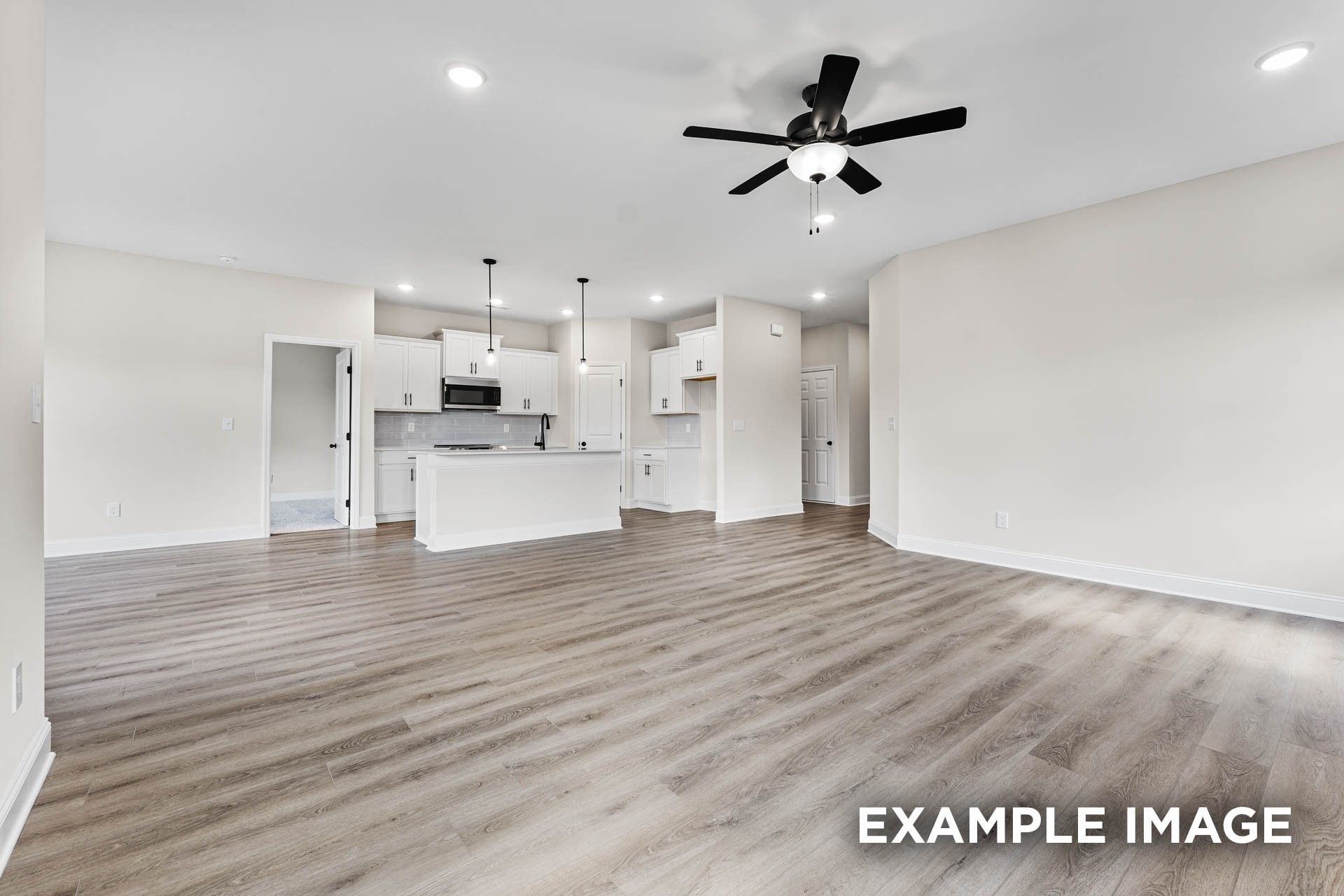 Open-concept living room and kitchen in The Franklin E floor plan at Bailey Park, Fayetteville, Tennessee.