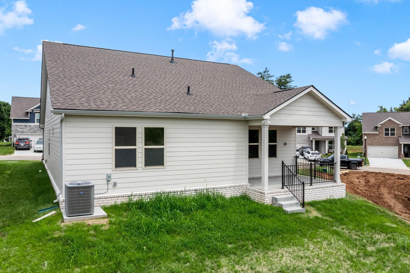 Back exterior of The Prairie C floor plan by Davidson Homes featuring a covered patio in Woods Crossing, Gallatin, Tennessee.