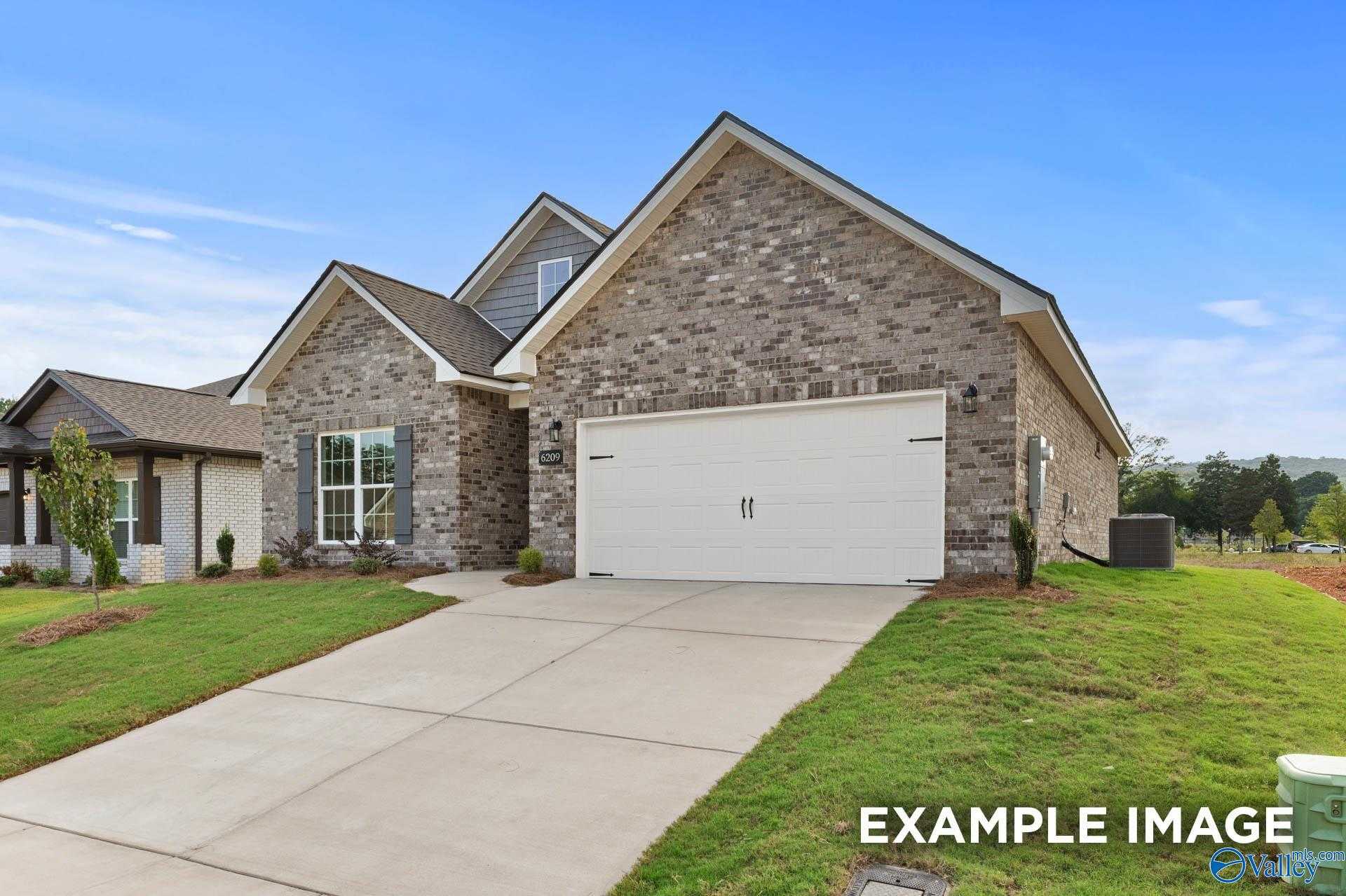 Modern brick single-story home with 2-car garage, driveway, and lush lawn in Wood Trail, Toney, Alabama by Davidson Homes The Franklin C