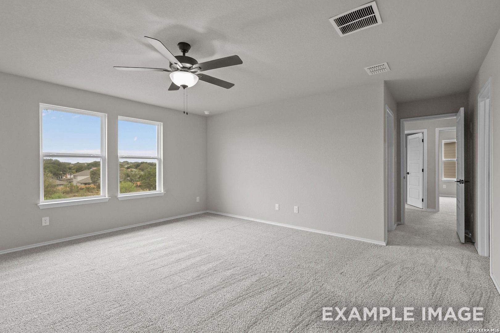 Spacious primary bedroom with ceiling fan and scenic windows in Davidson Homes The Murray H plan, Converse, Texas