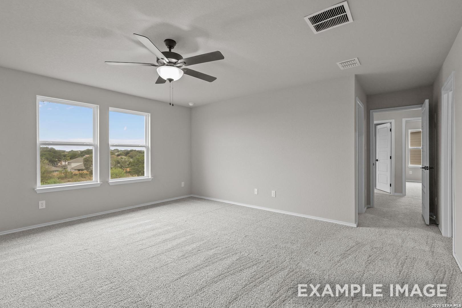 Spacious primary bedroom with ceiling fan and scenic windows in Davidson Homes The Murray H plan, Converse, Texas