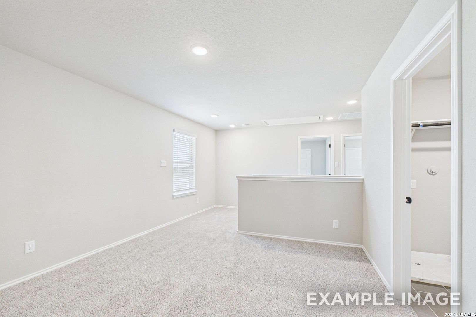 Spacious carpeted game room in The Charlotte B floor plan by Davidson Homes at Cedar Heights in San Antonio, Texas.