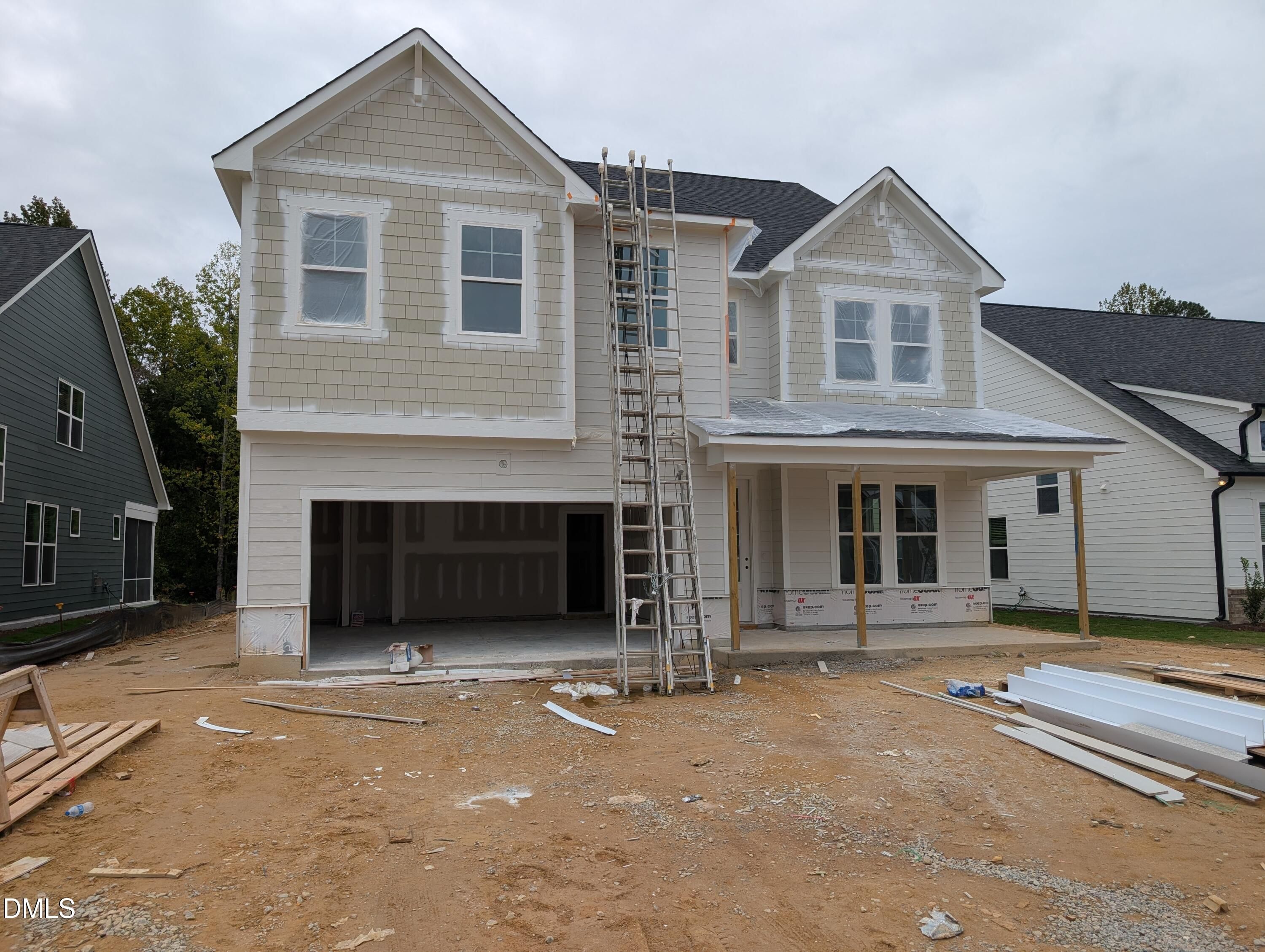 New construction 3-story home with 2-car garage and covered porch under construction in Wendell Ridge, Wendell, North Carolina