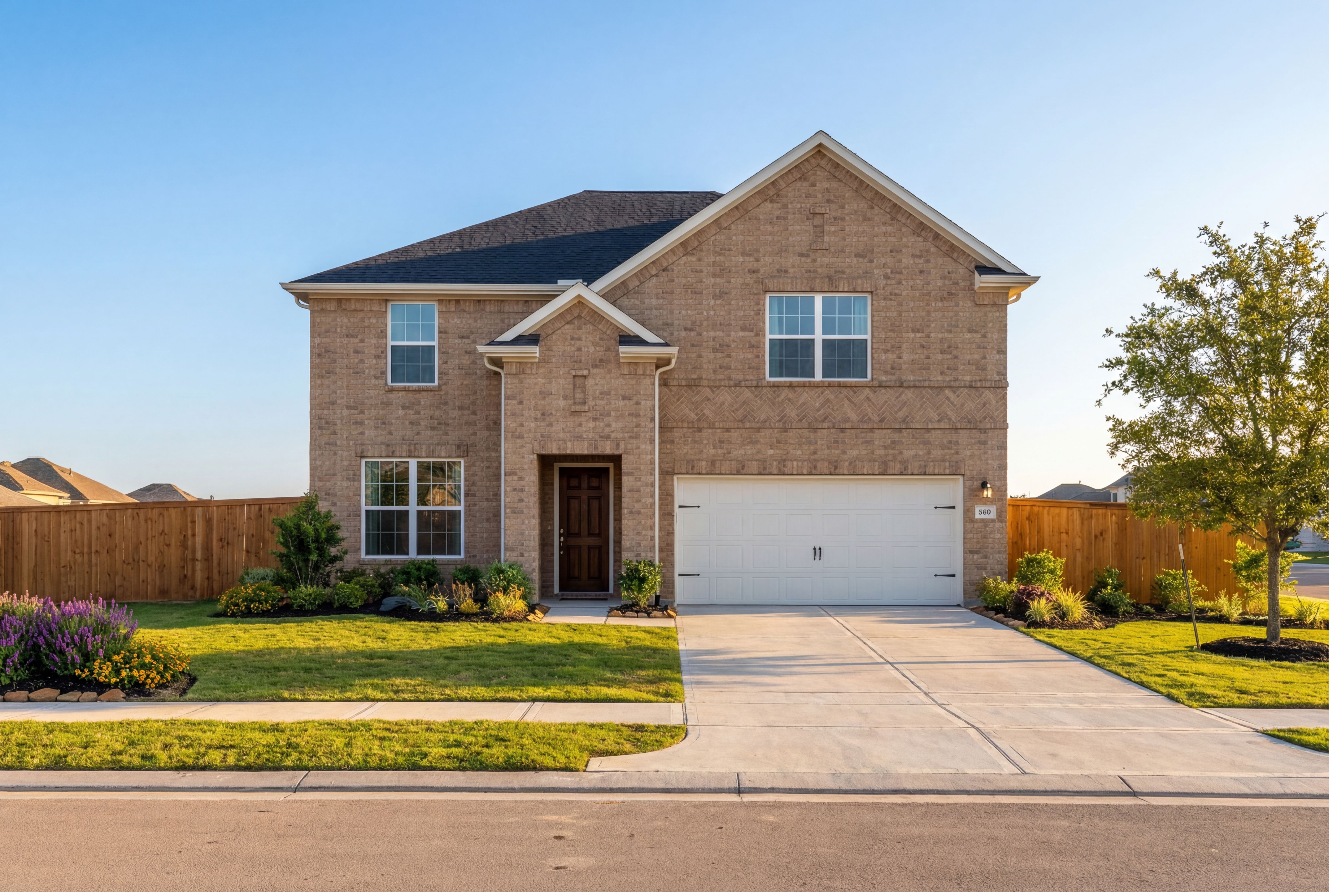 Two-story Sequoia A brick home elevation by Davidson Homes in Crosby TX, featuring 2-car garage, driveway, and landscaped yard