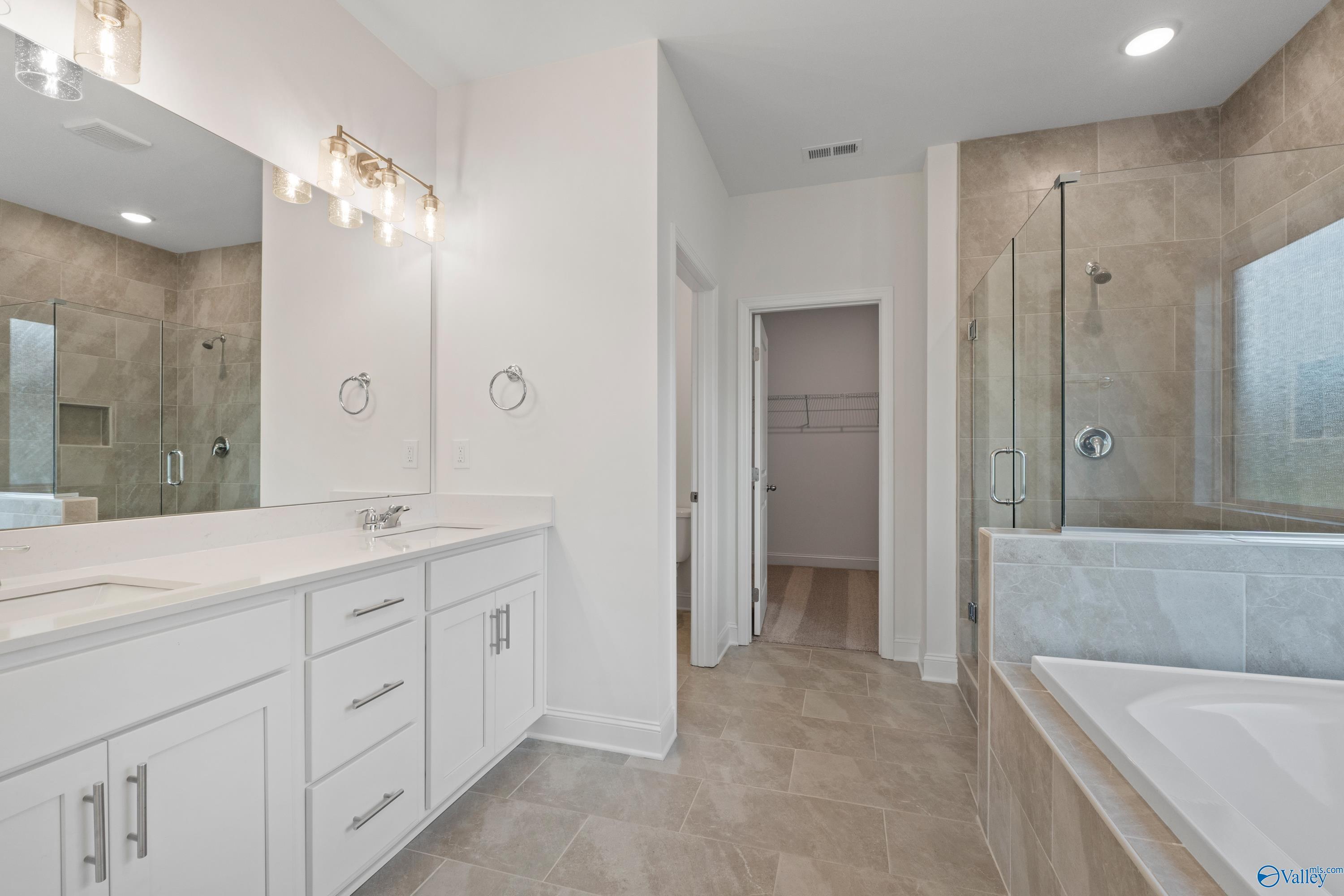 Luxurious master bathroom with double vanity, glass shower, soaking tub in Davidson Homes The Rockford B, Toney, Alabama