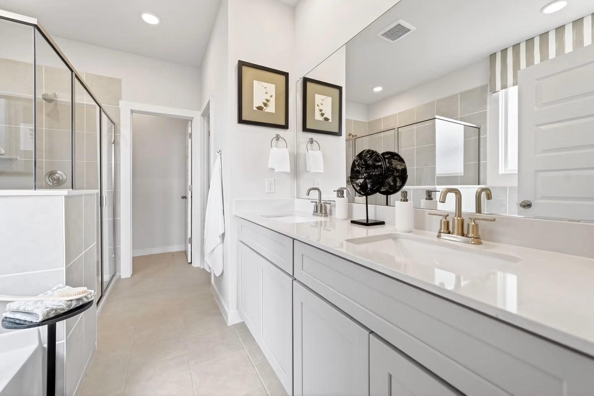 Modern master bathroom with dual vanity and walk-in shower in The Laurel I floor plan by Davidson Homes in Heartland, Texas.
