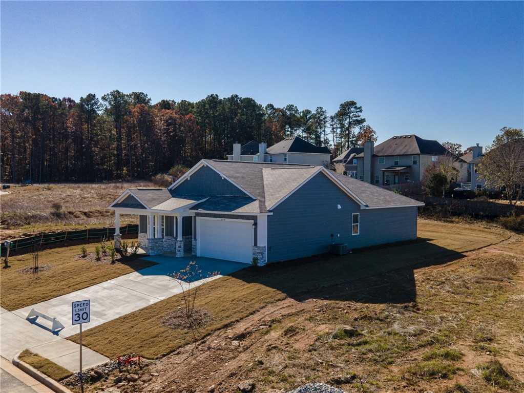 Blue single-story 4-bedroom home with 2-car garage, front porch, and for sale sign in Anderson Lakes, Opelika, Alabama by Davidson Homes The Luna B