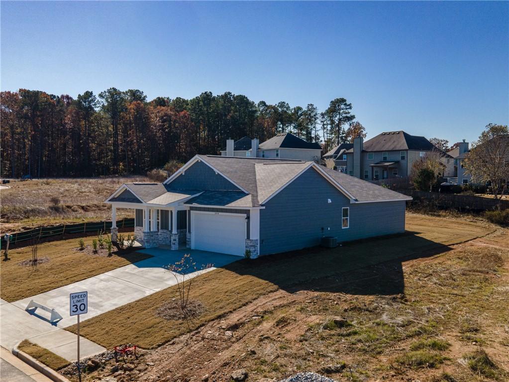 Blue single-story 4-bedroom home with 2-car garage, front porch, and for sale sign in Anderson Lakes, Opelika, Alabama by Davidson Homes The Luna B