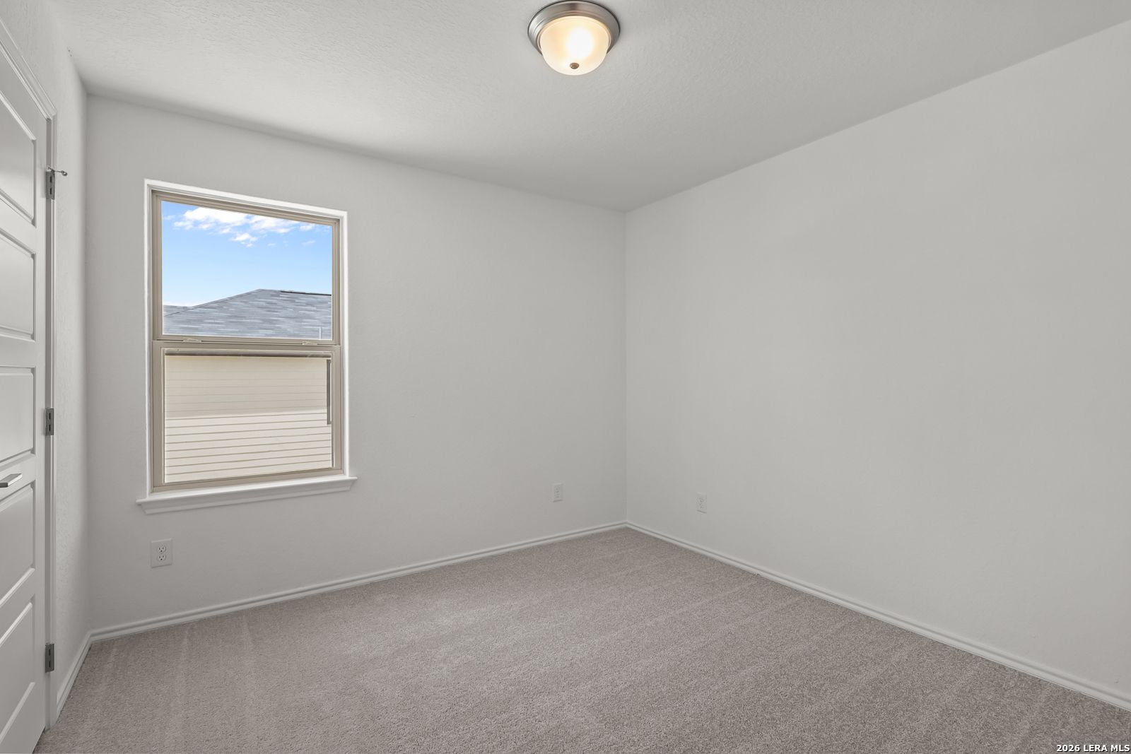 Bright, carpeted bedroom with neutral walls in The Gillian C floor plan by Davidson Homes in San Antonio, Texas.