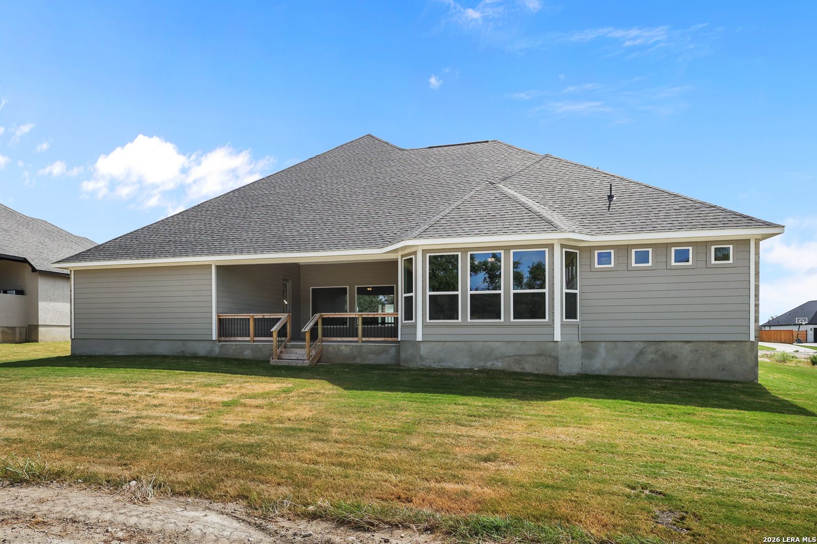 Rear exterior view of The Summerlin B floor plan by Davidson Homes with a covered patio in Potranco Oaks, Castroville, Texas.